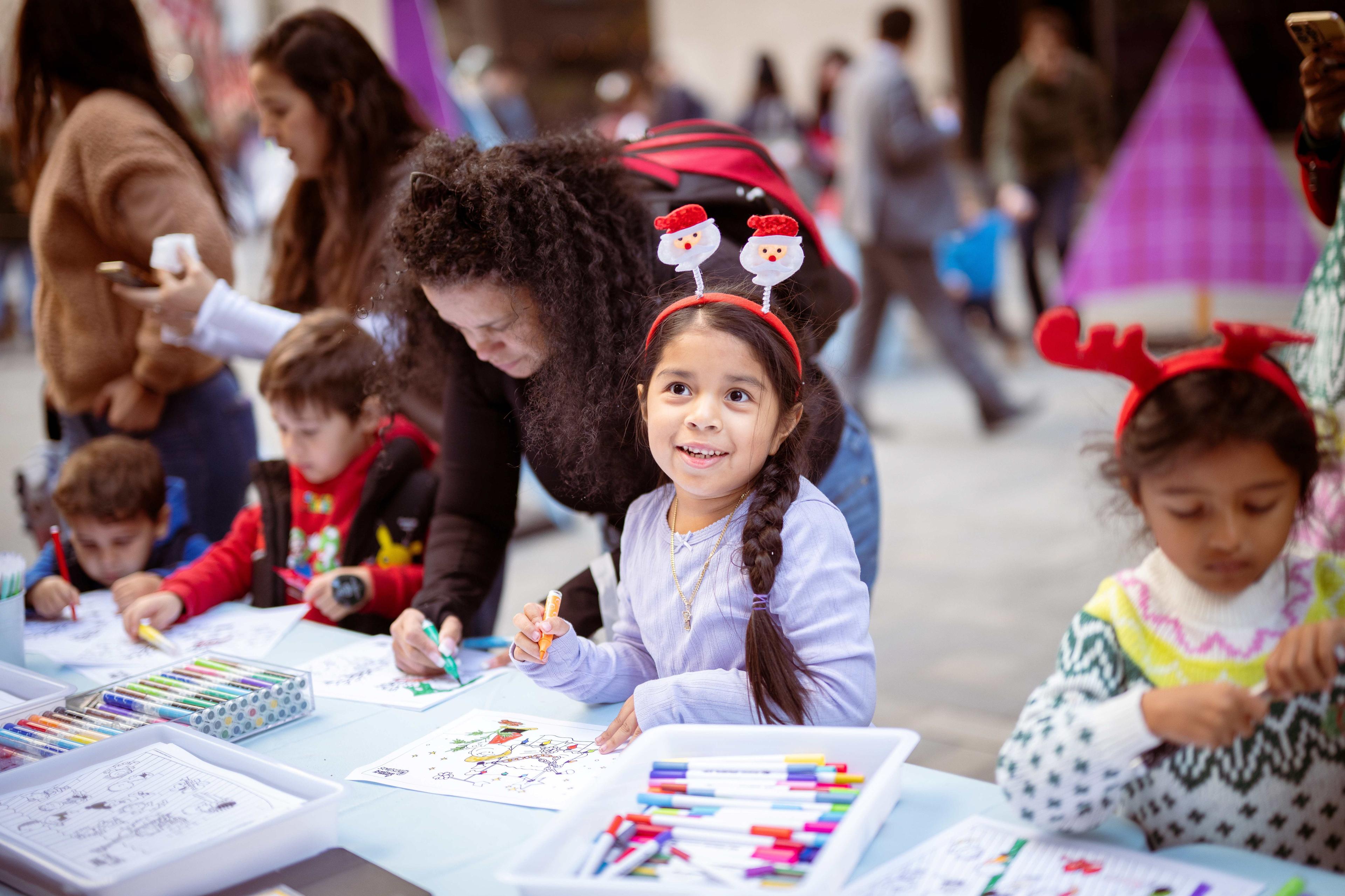 children at meet the tree day doing a craft