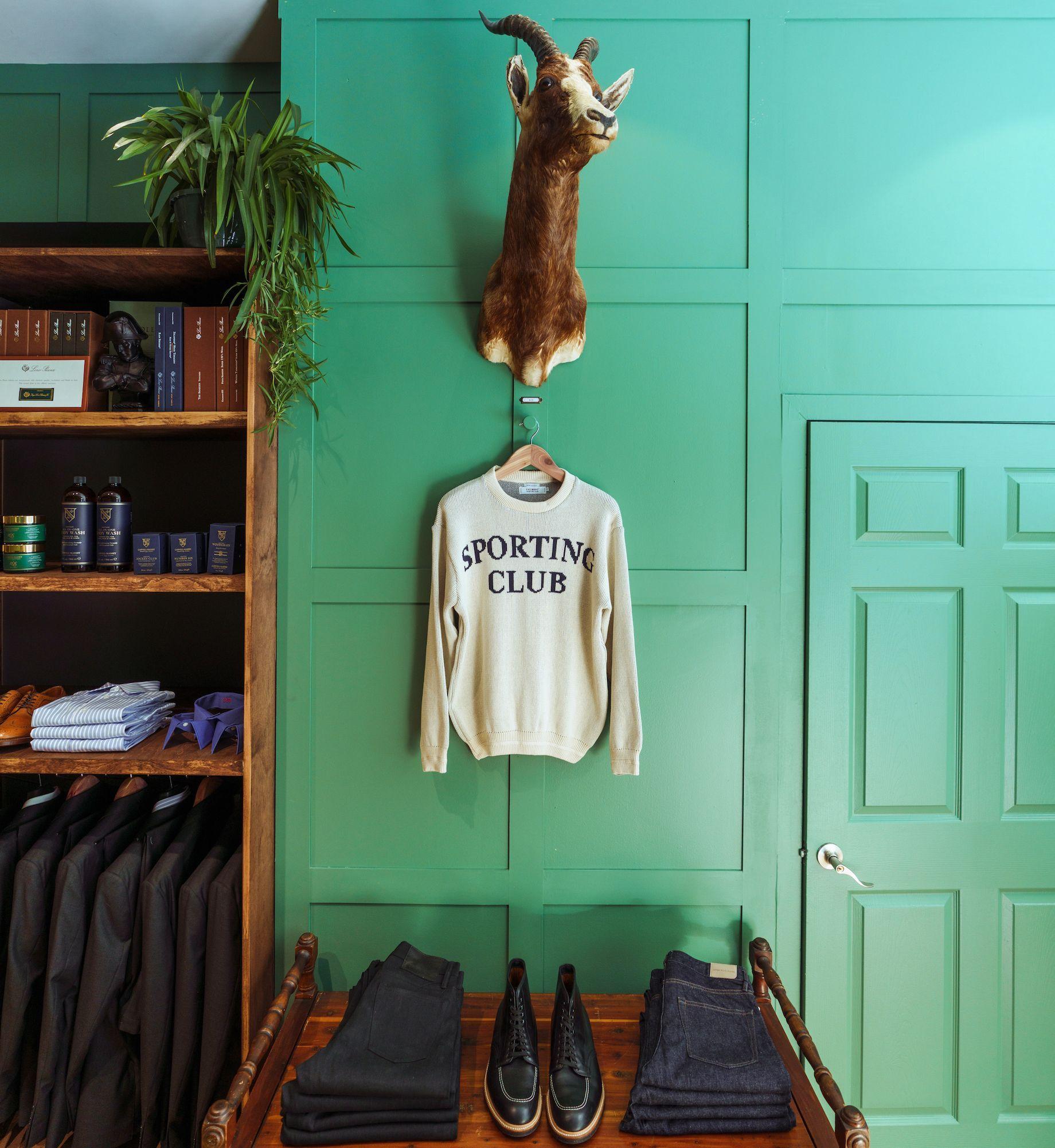 Sweater hanging from a mounted animal head at Freemans Sporting Goods at Rockefeller Center
