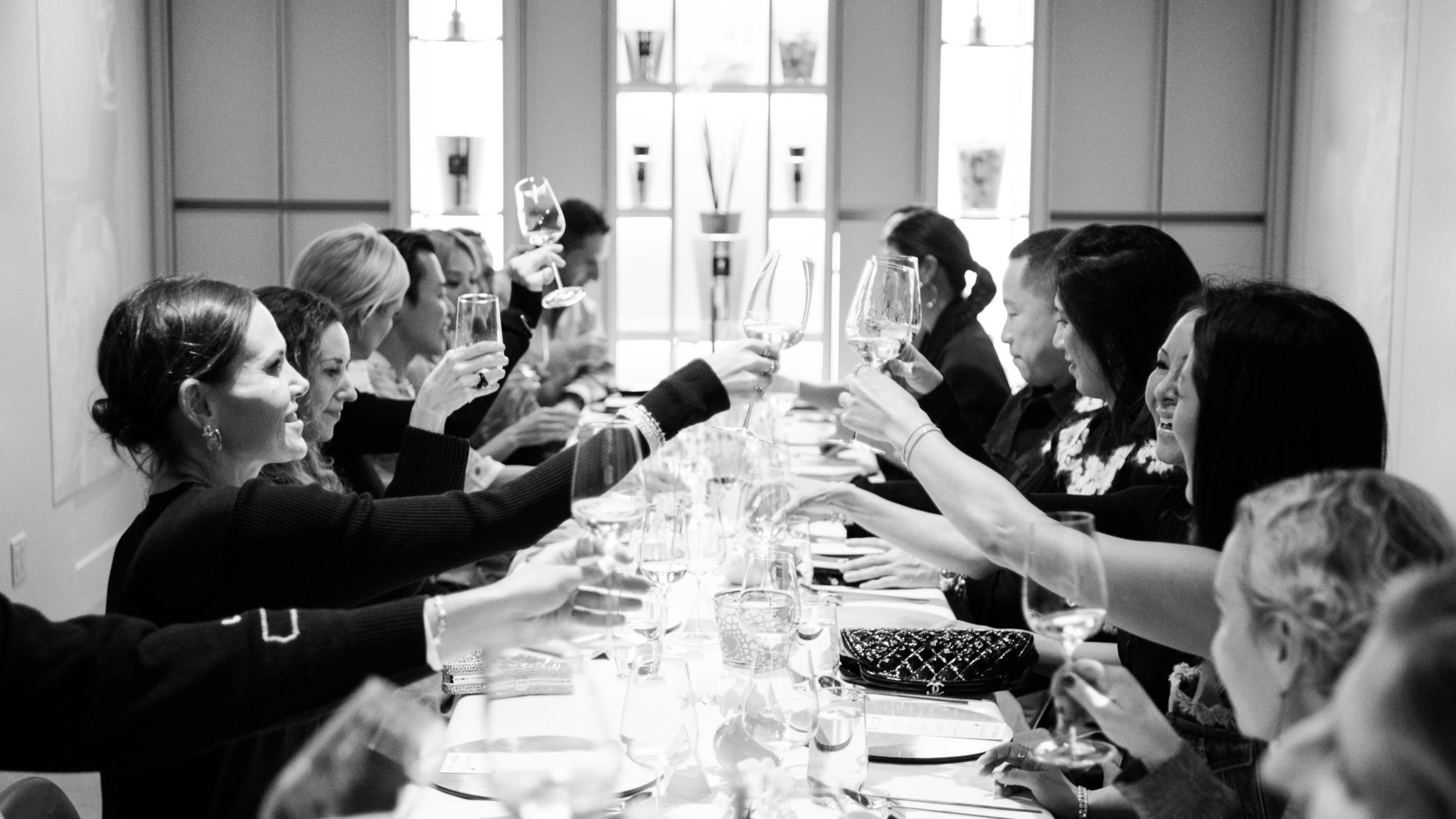 a group cheersing at a large table