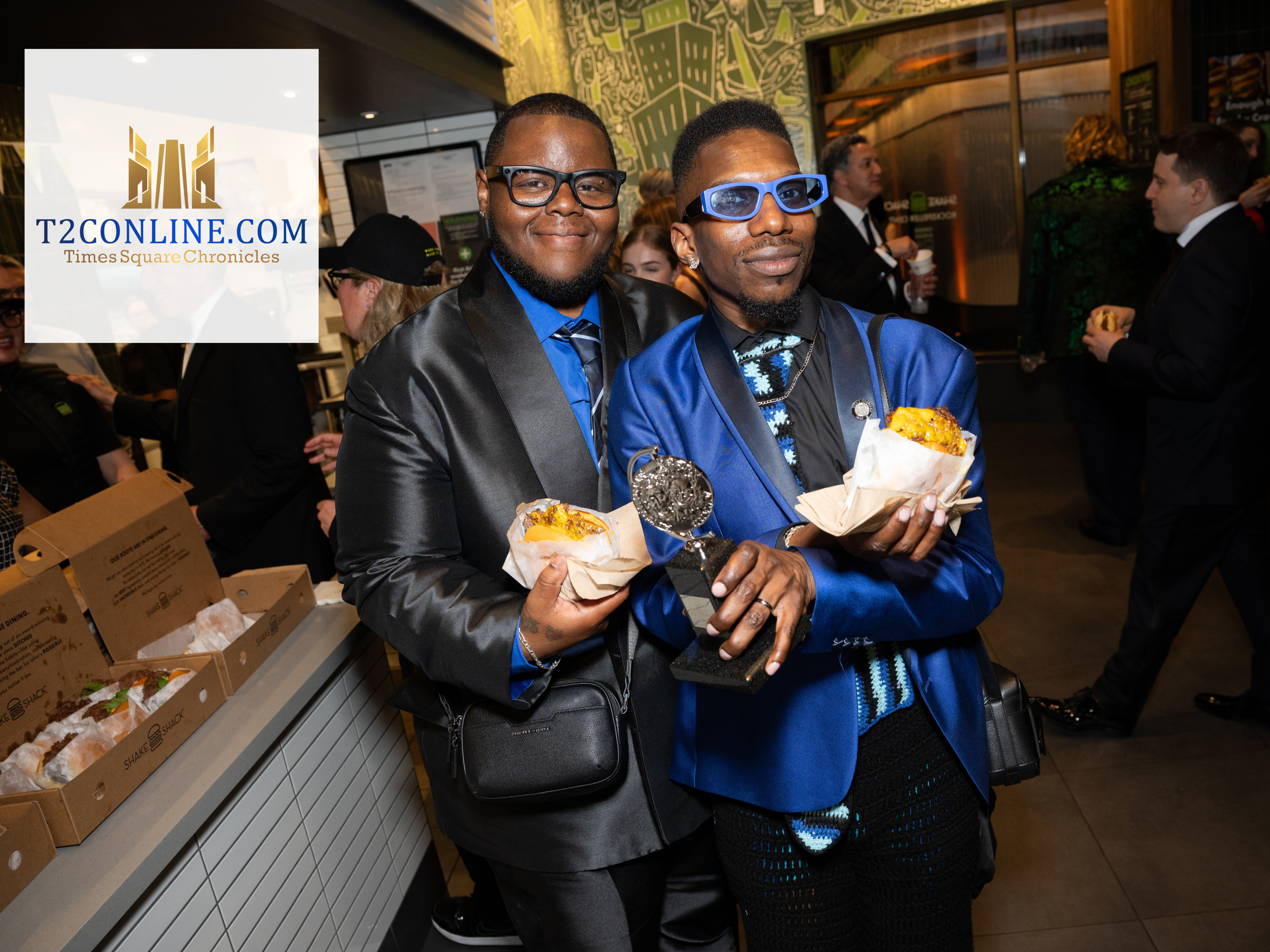 two tony award winners smiling with food
