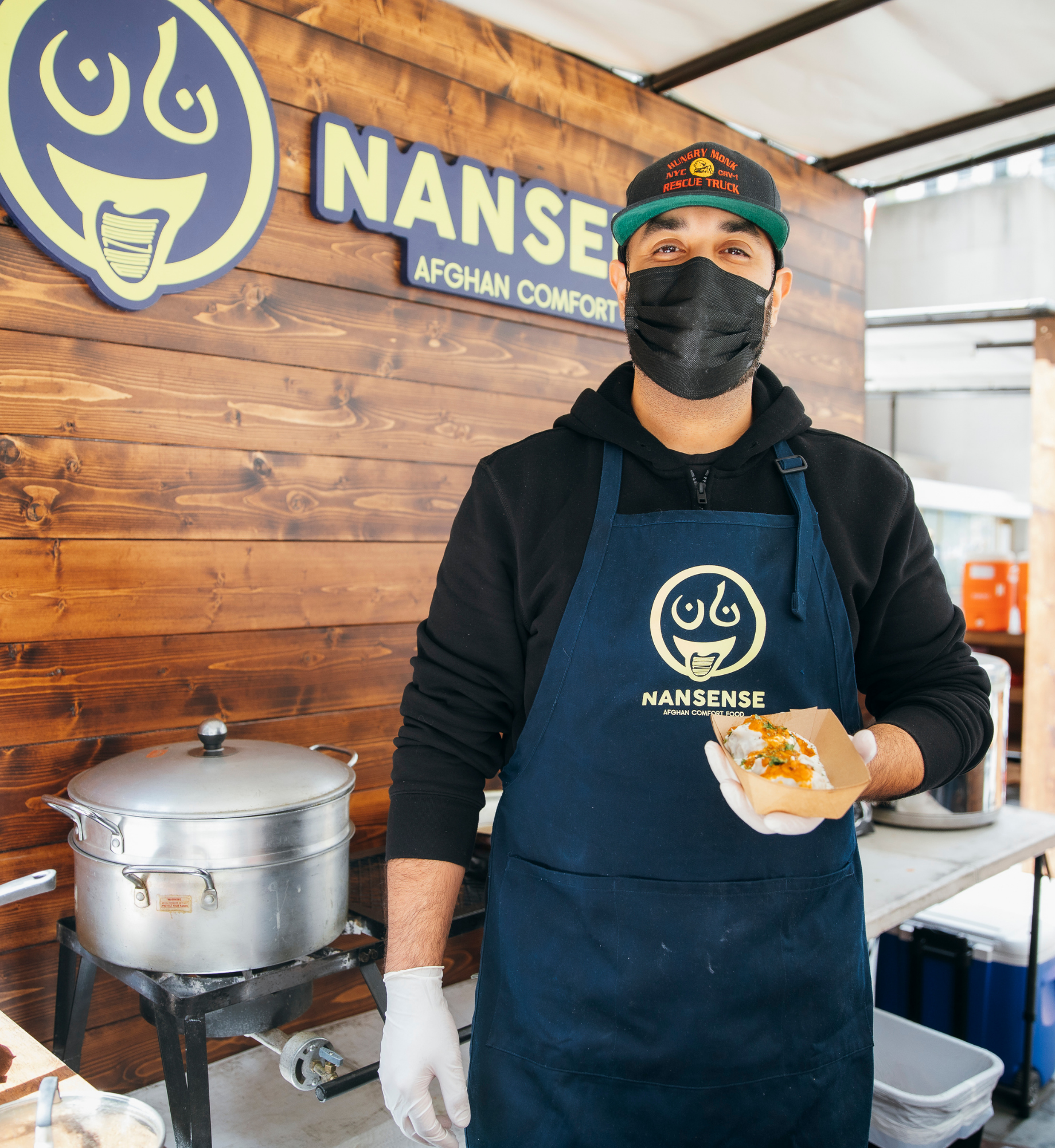 A employee standing in the Nansense stand at the Queens Night Market Outpost at Rockefeller Center