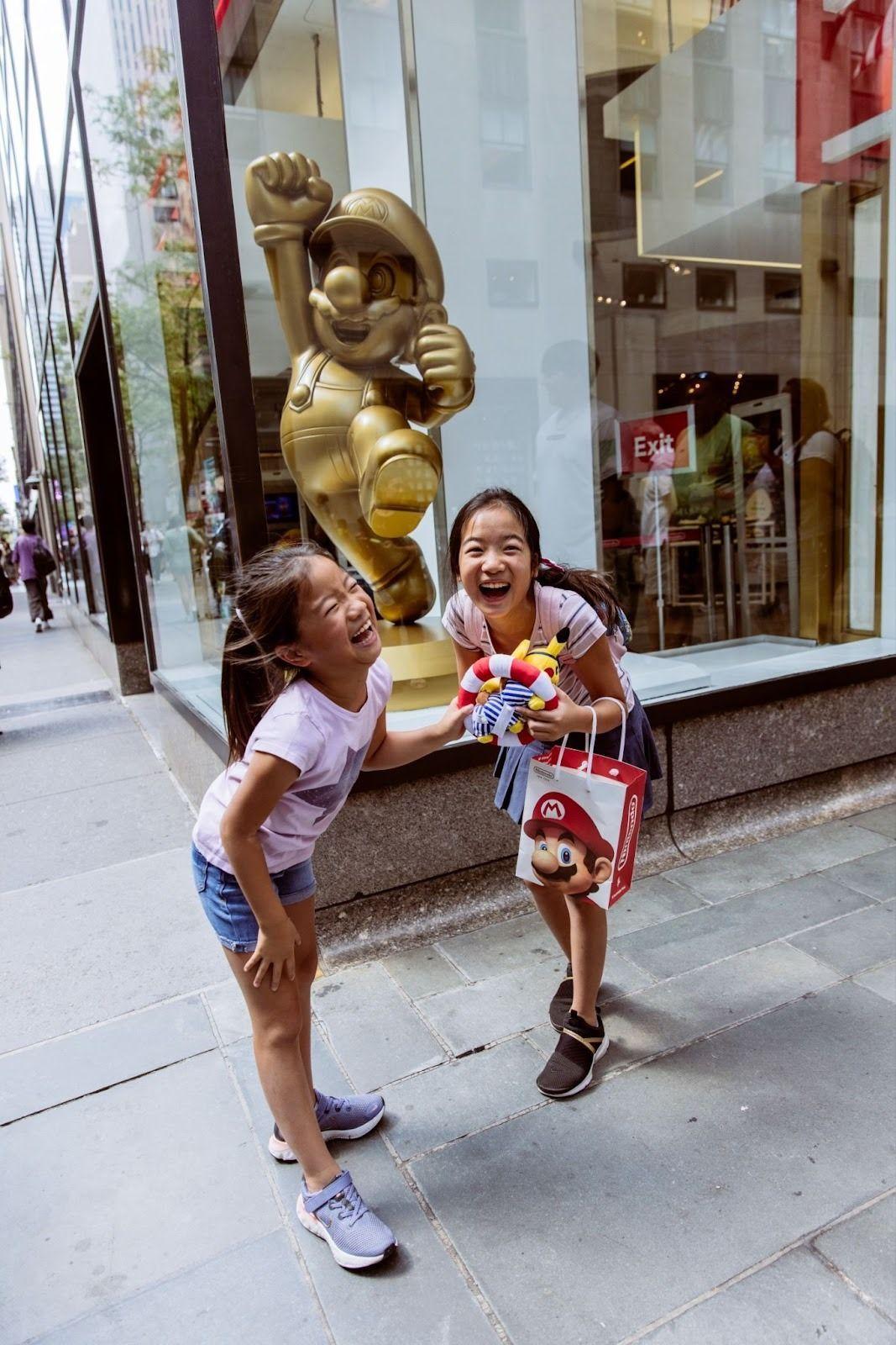 two girls smiling at rockefeller center