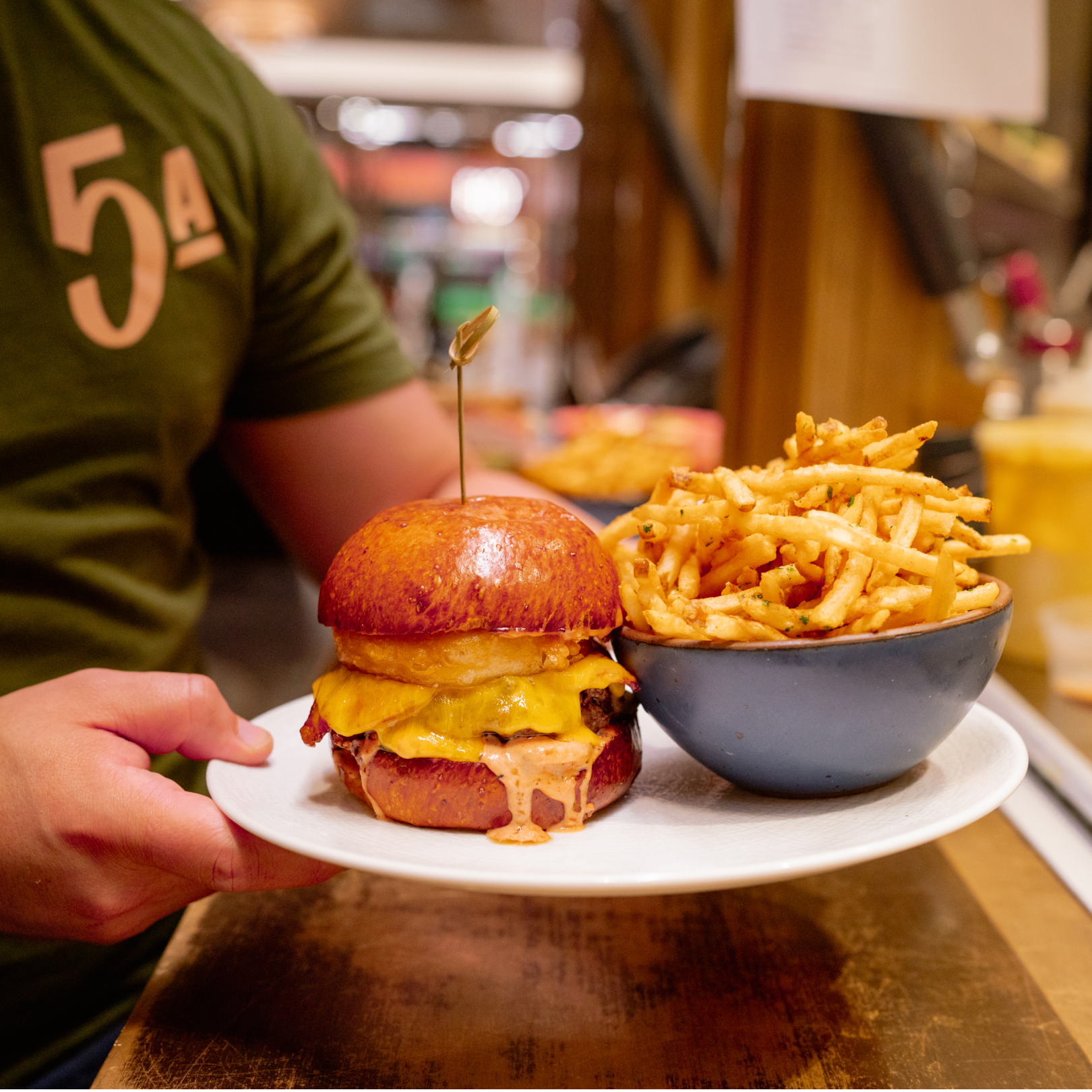 Double cheeseburger and bowl of fries from 5 Acres at Rockefeller Center