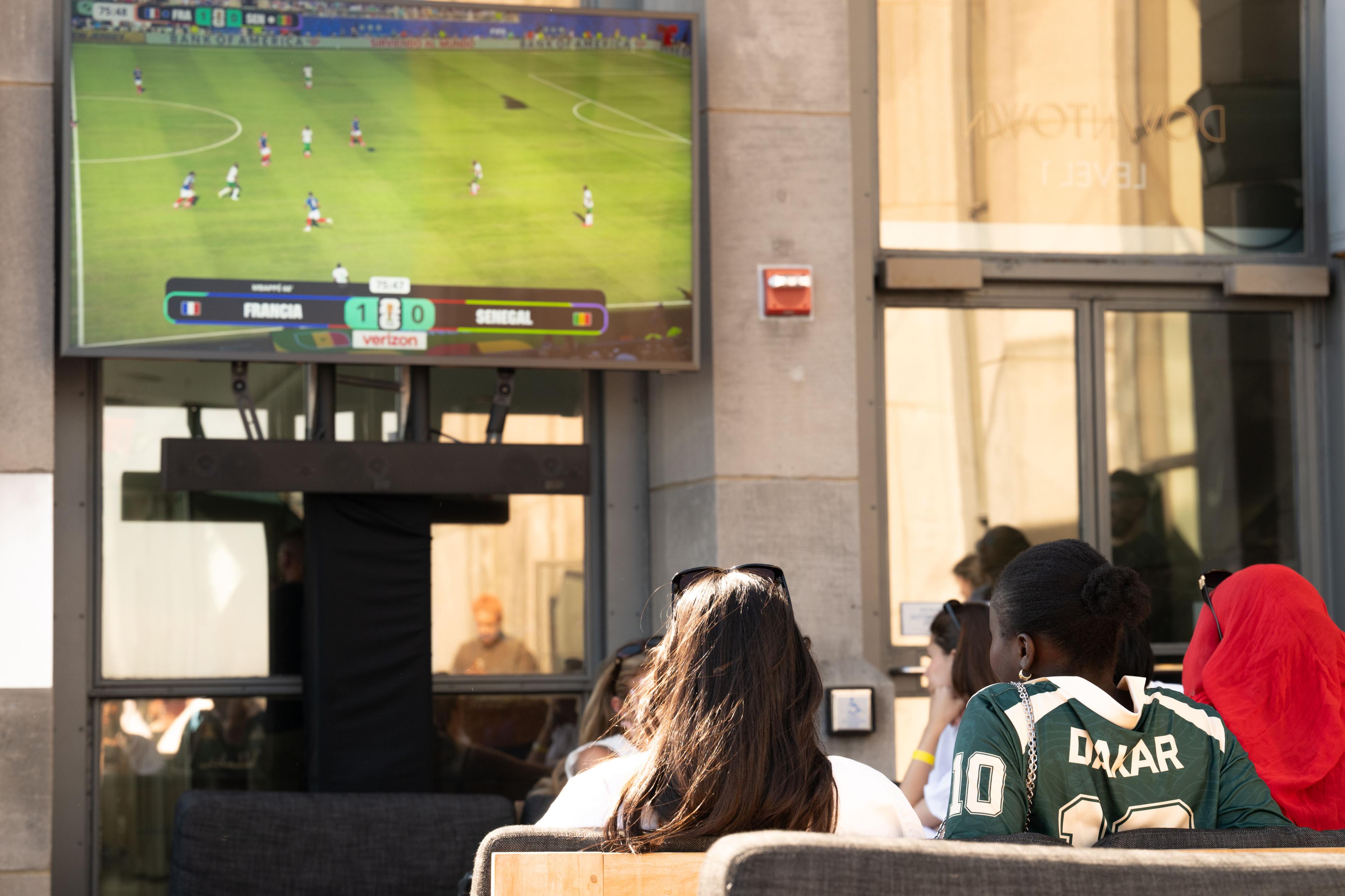 people watching soccer at top of the rock