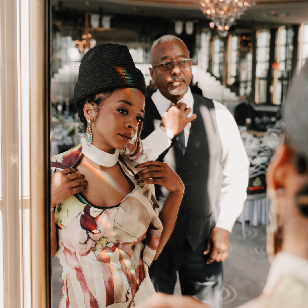 Broadway star Kara Young posing in front of a mirror with her dad, Klay Young