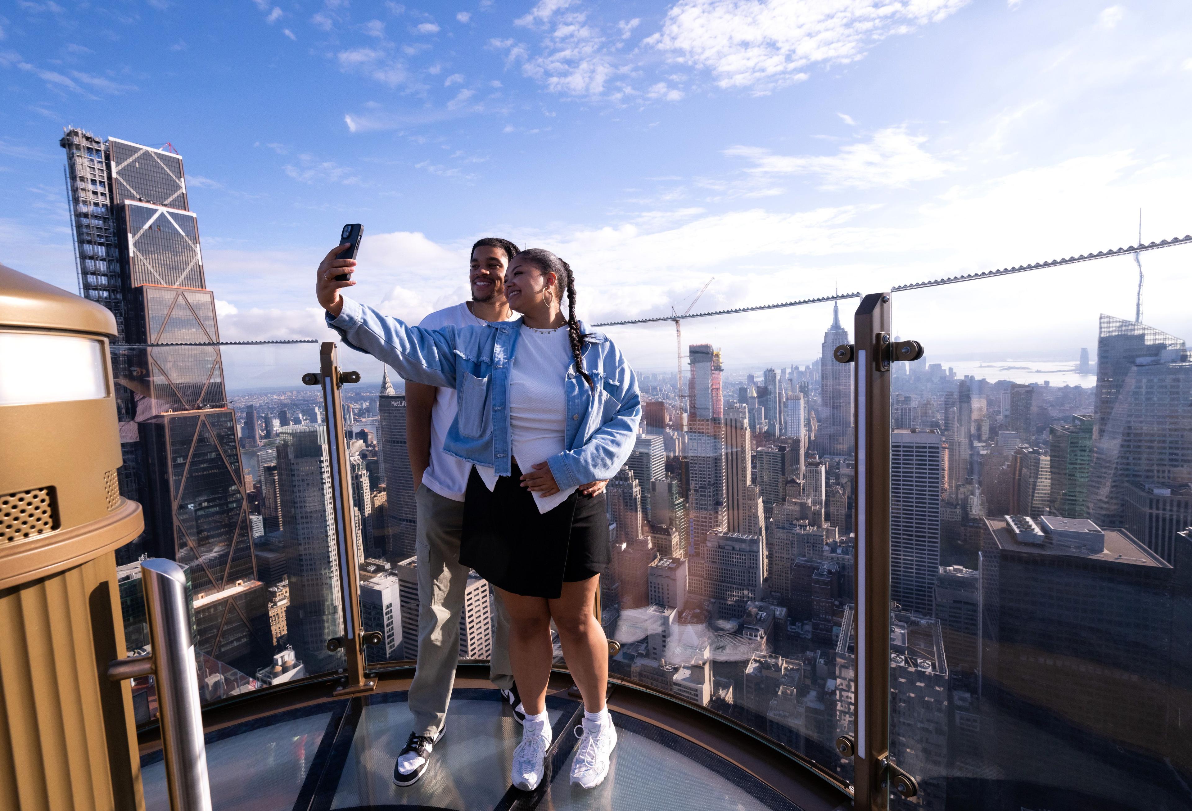 Couple taking photos on SKYLIFT