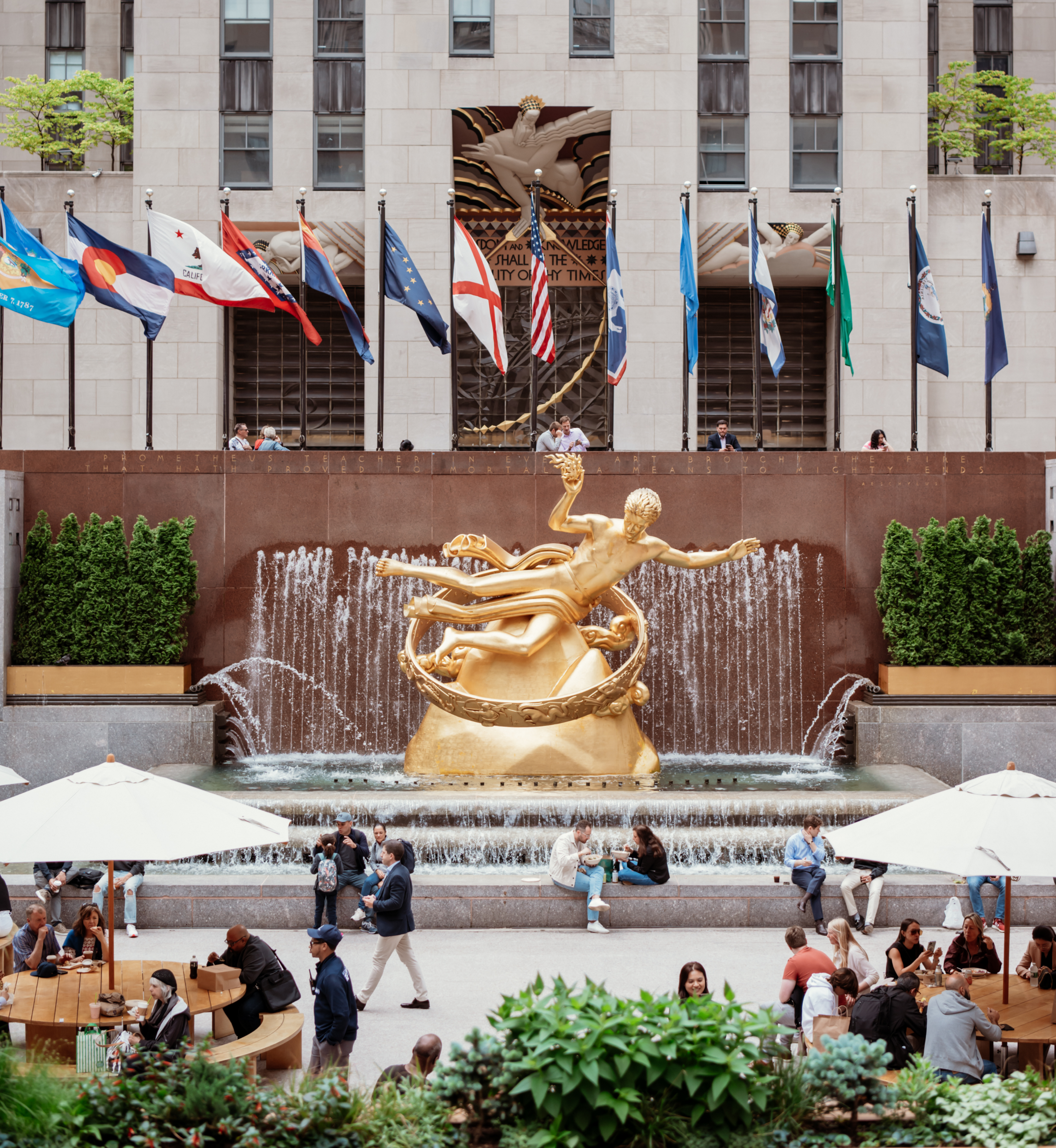 Aerial view of people sitting at tables and near the Prometheus statue at The Rink