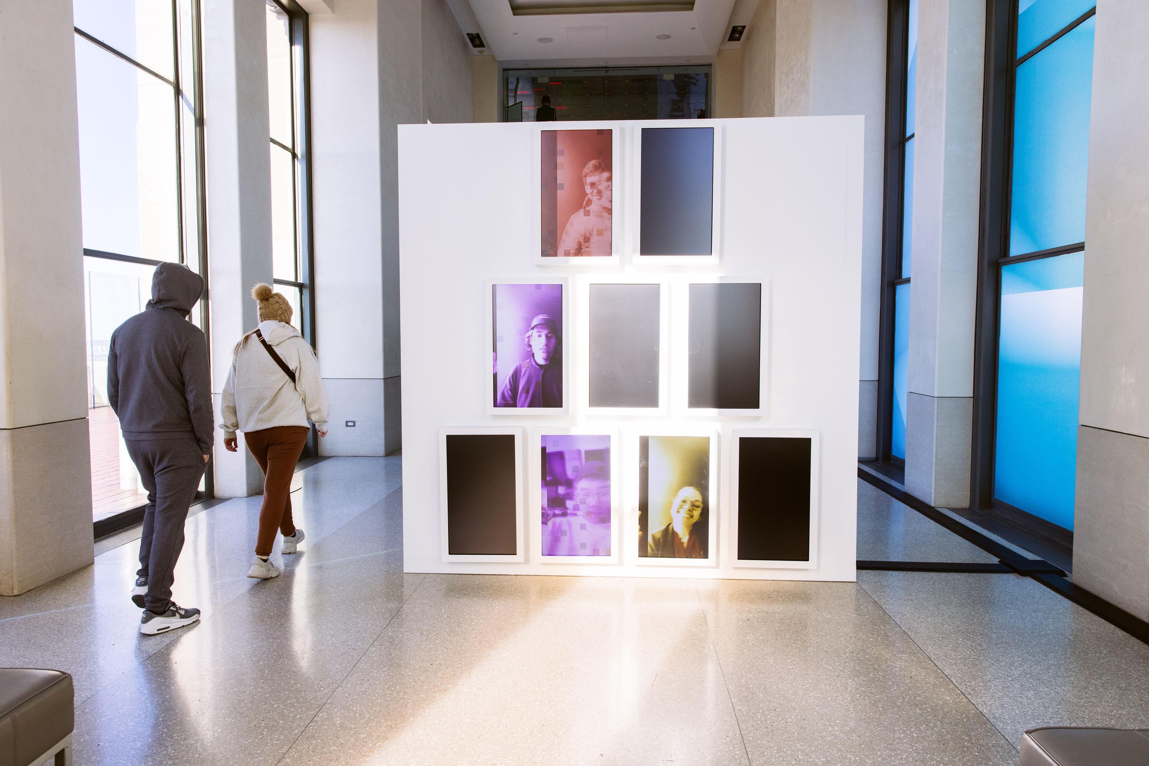 Visitors viewing artist Diana Sinclair's "Reflections" exhibit at Top of the Rock