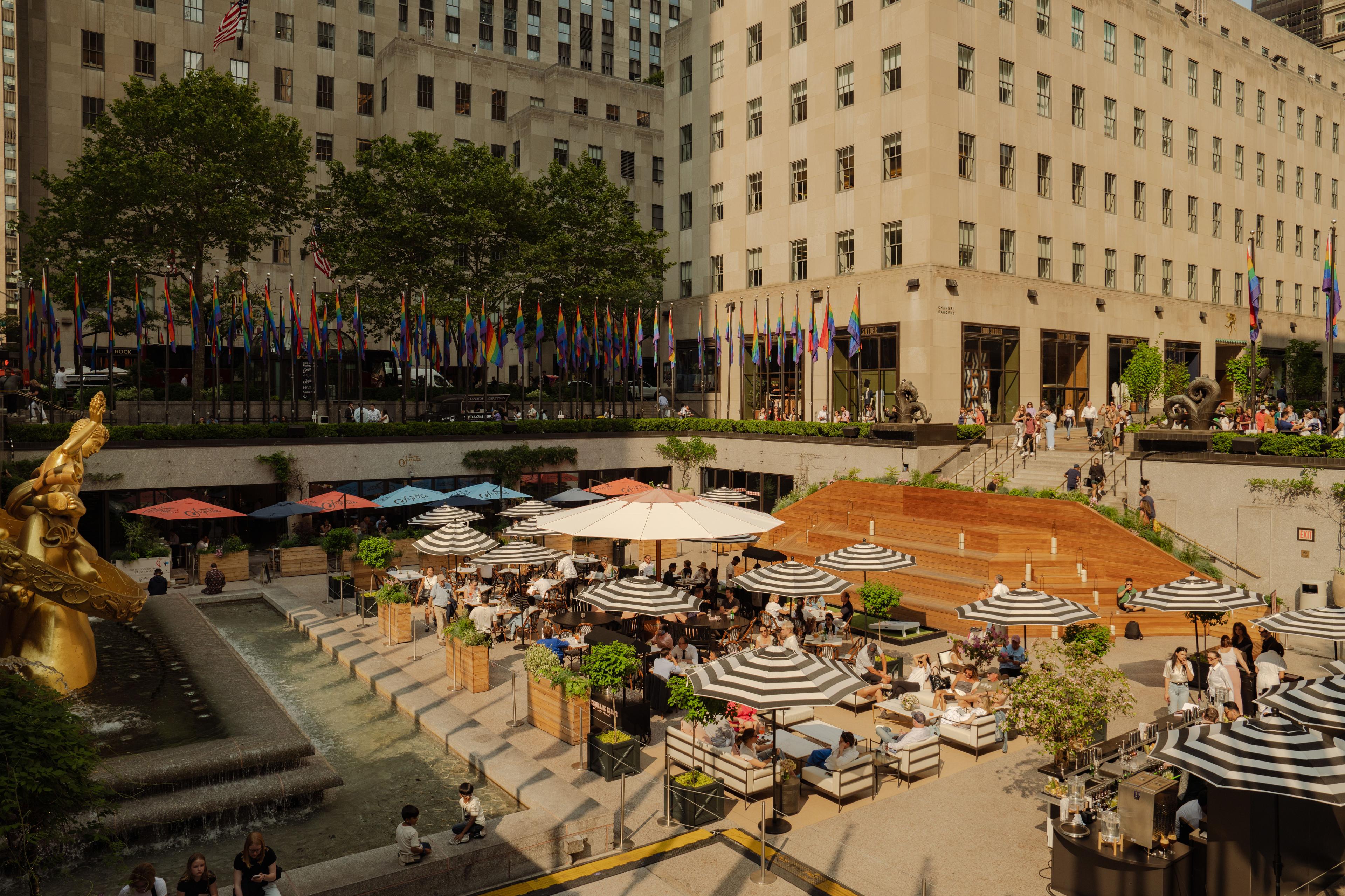 tables and umbrellas at the rockefeller center summer rink