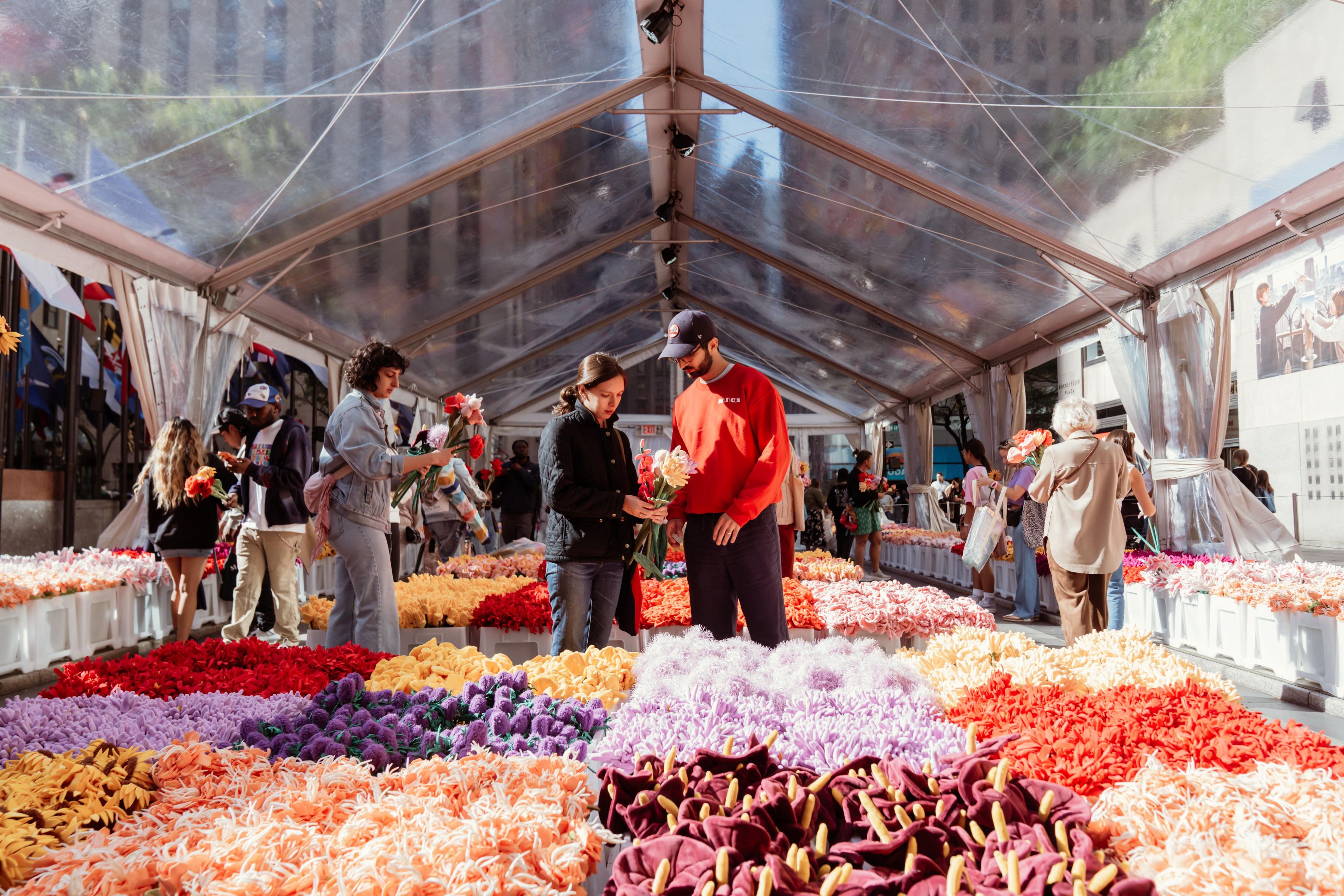 View of the flower market with people shopping boxes of flowers