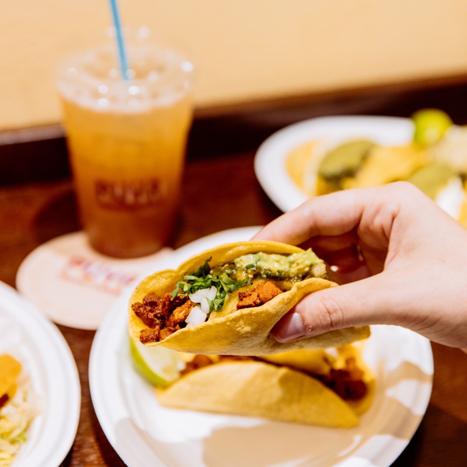 Hand holding a taco from Puya at Rockefeller Center