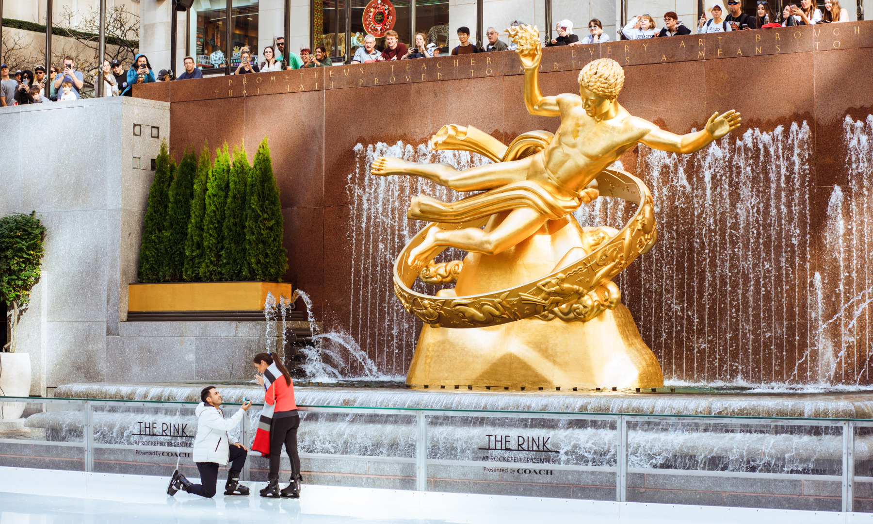 A man proposing to a woman at The Rink at Rockefeller Center