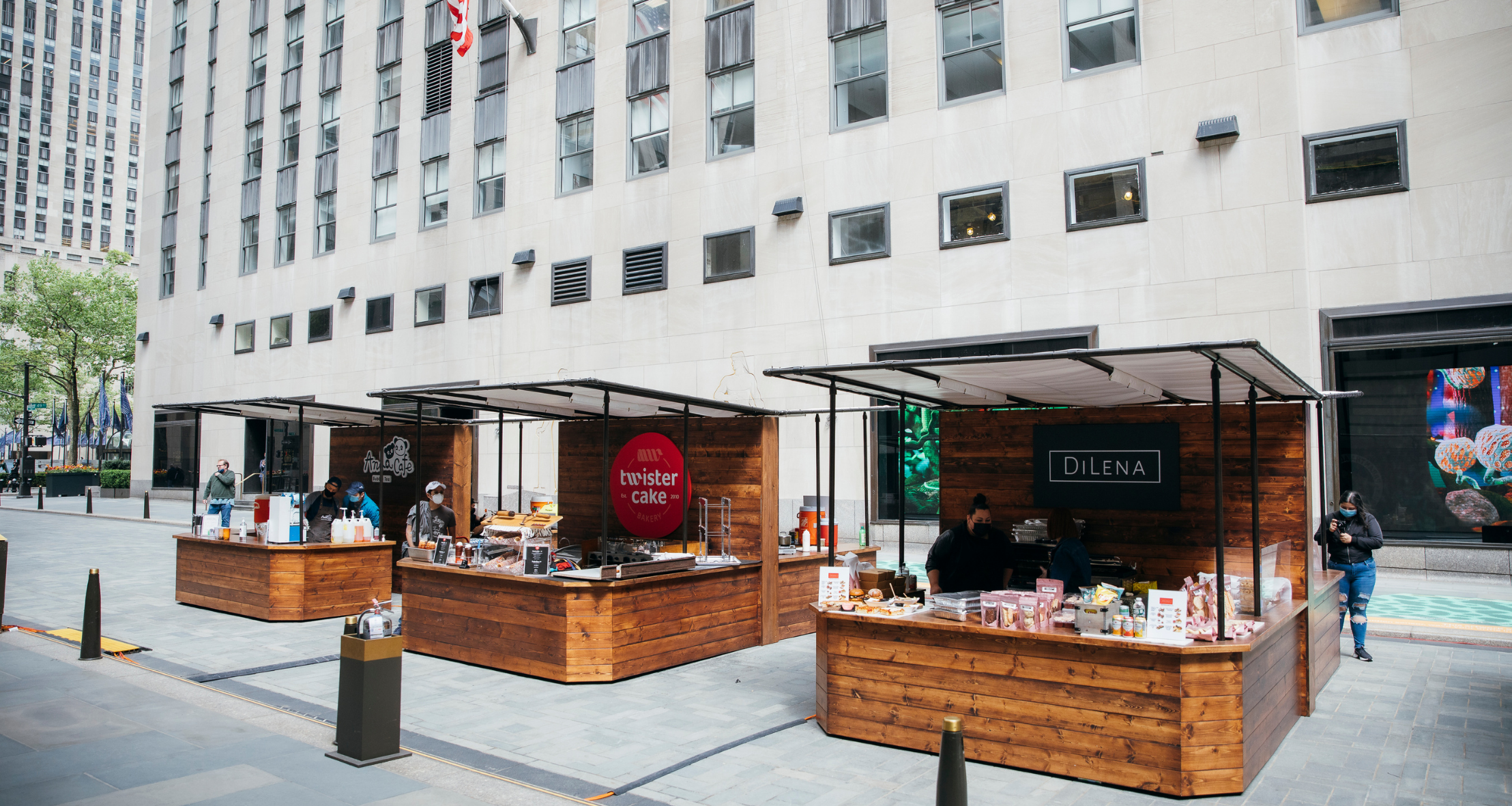 A snapshot of three food stands at the Queens Night Market Outpost at Rockefeller Center